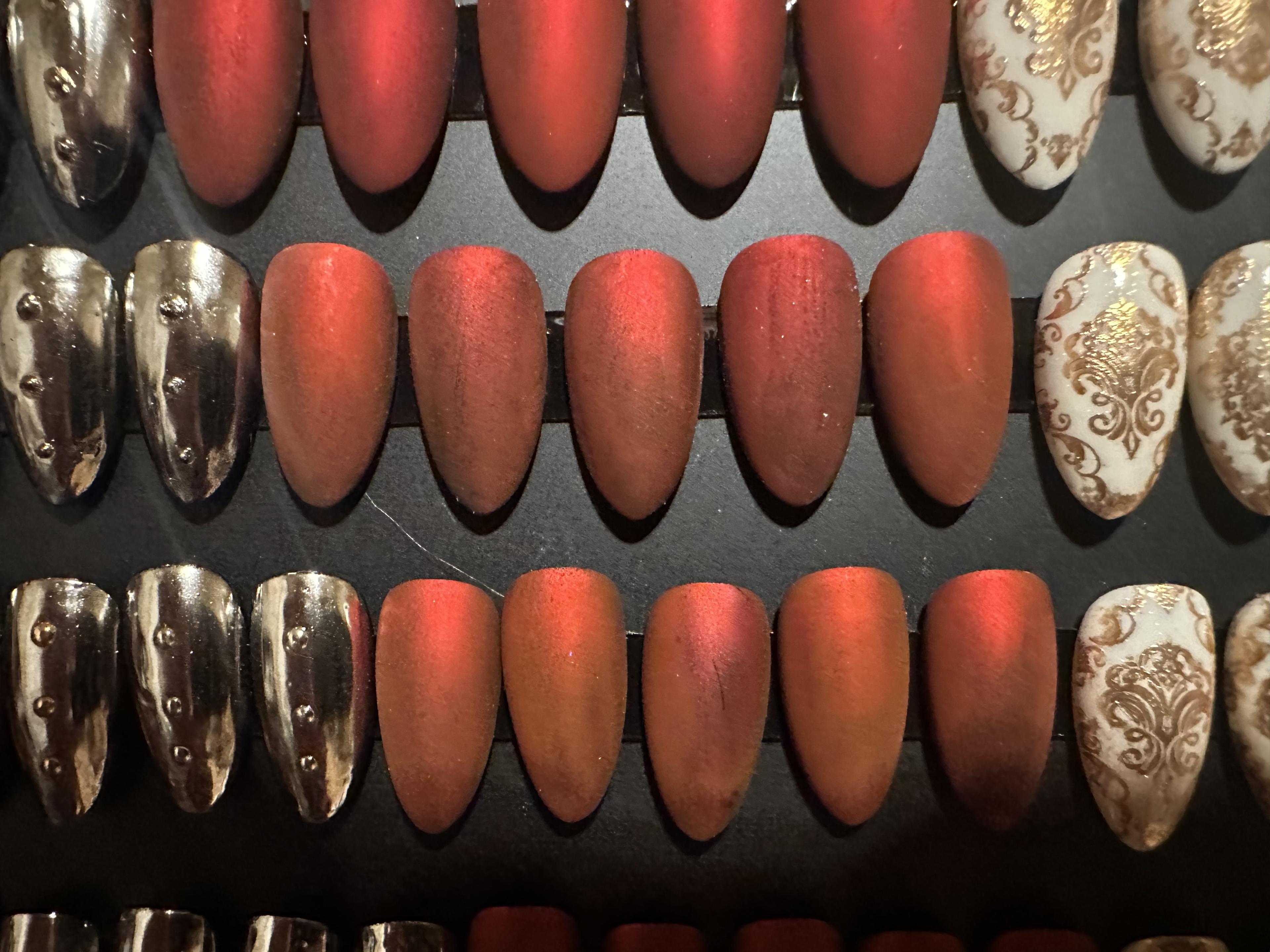 Mixed armor, coral, and gold ornate nail designs