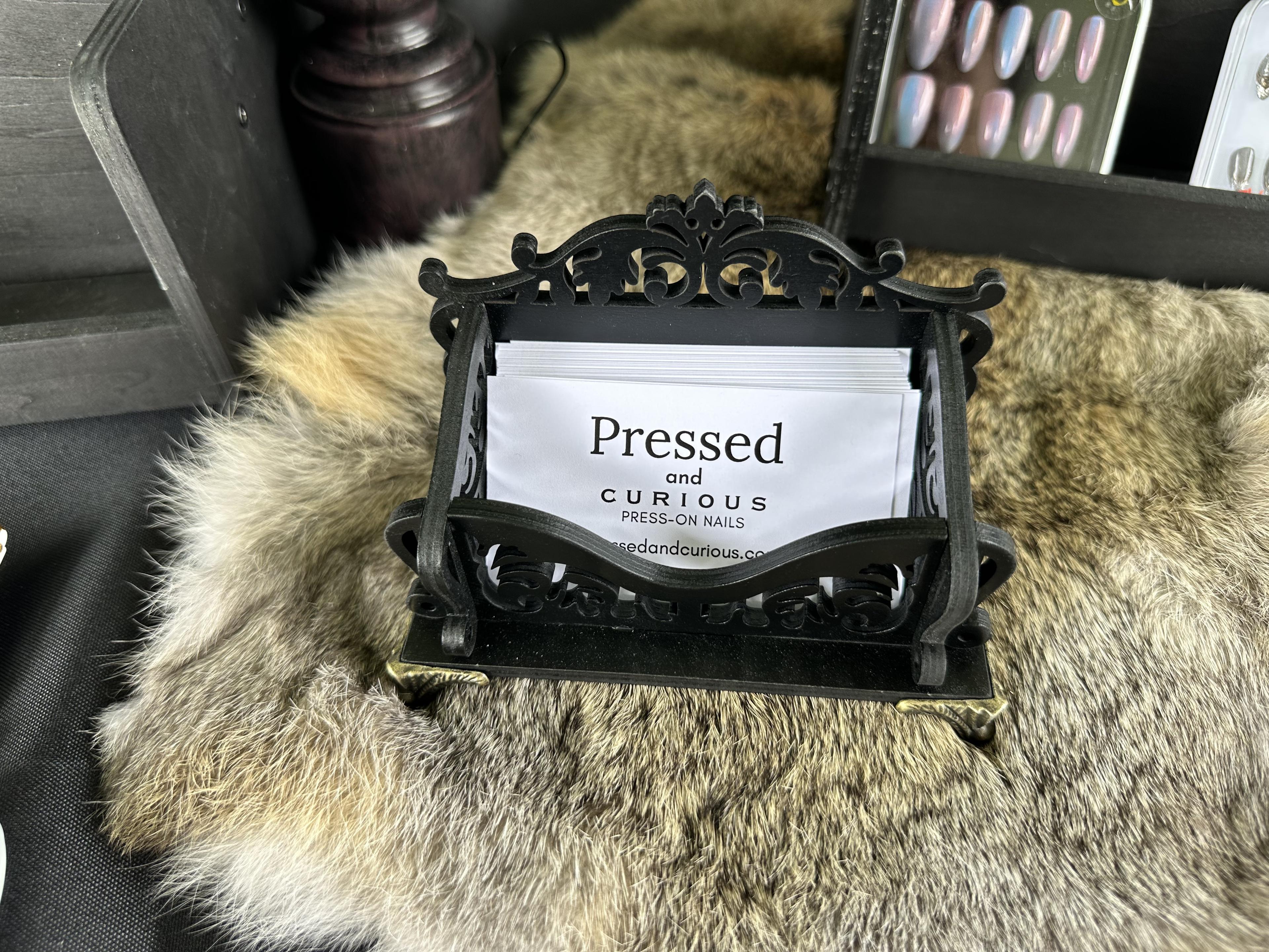 Pressed and Curious business cards on display