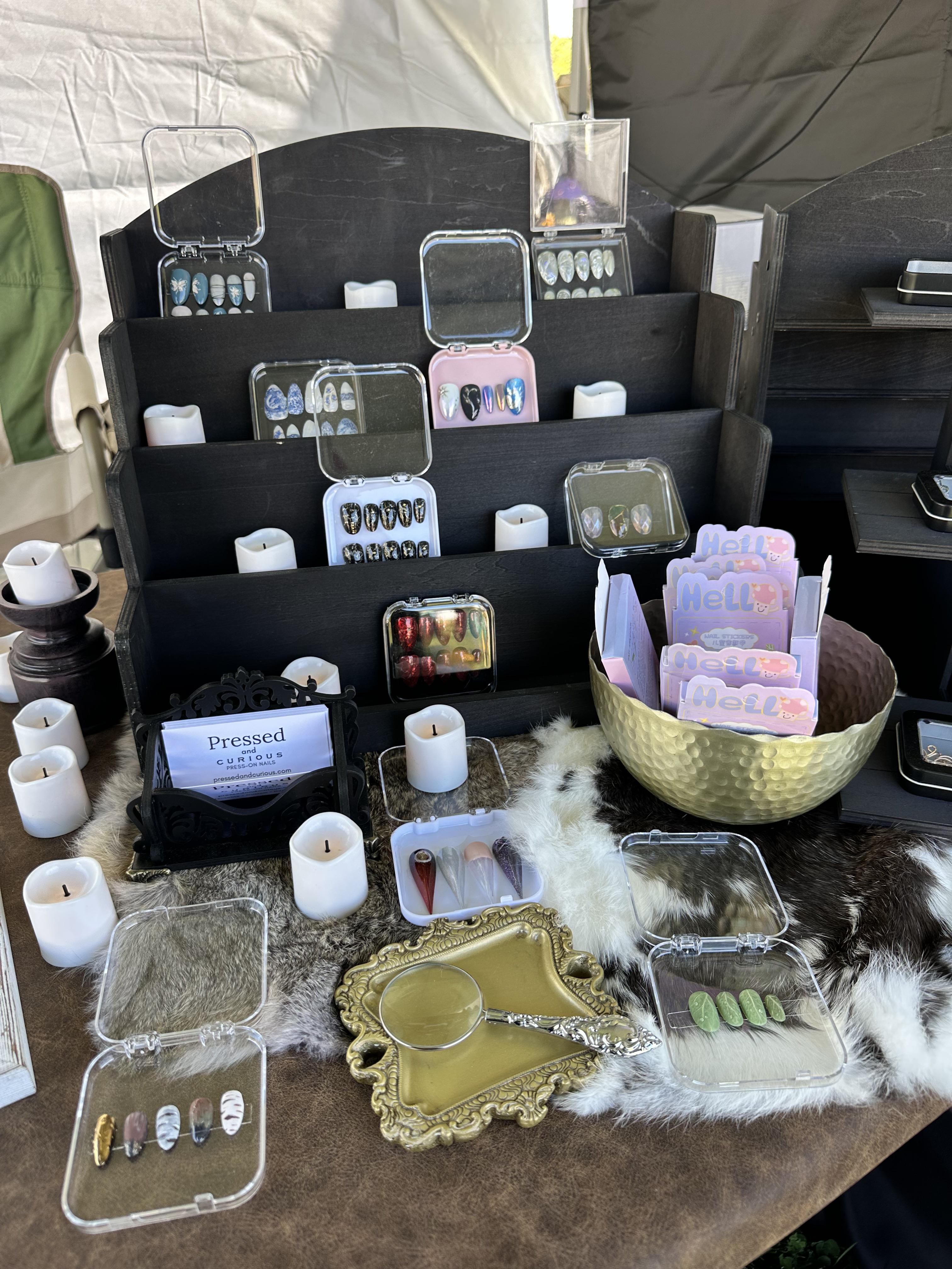 Booth table with nail sets in cases
